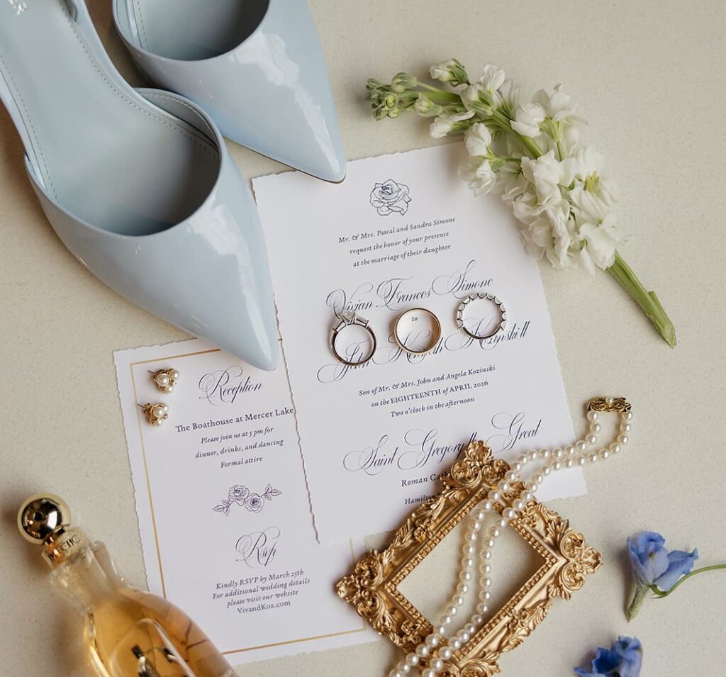 Wedding invitations with rings, blue shoes, and other wedding details