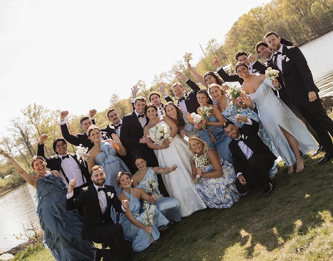 Wedding party celebrating outside with the couple